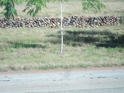 An unusual stone wall along the road out of the city.